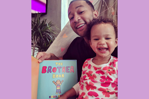 Image of John Legend and his daughter reading The Brother Book!