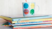 Image of stacked childrens book with a small cup on top